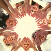 Women's faces and hands in a circle