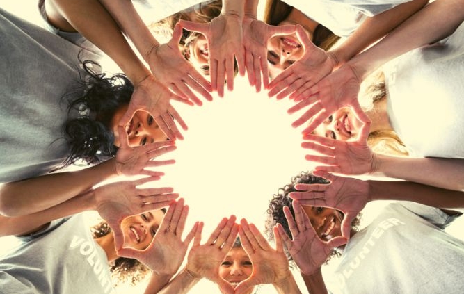 Women's faces and hands in a circle