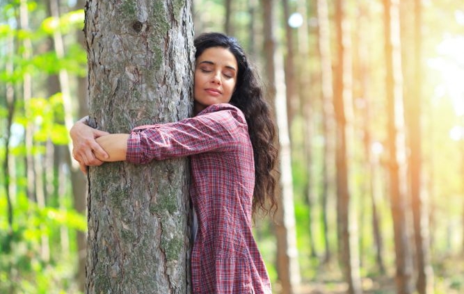 Woman hugging a tree